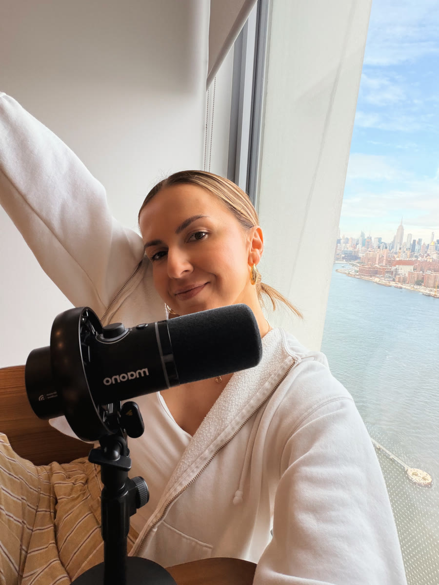 Anita Kirkovska recording with a microphone by a window